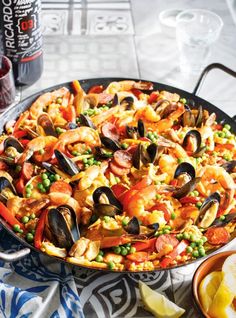 seafood paella with shrimp, mussels and capers in a skillet