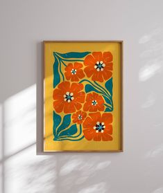 an orange flowered painting hangs on the wall