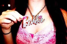 a woman wearing a bra with the word barbie written on it