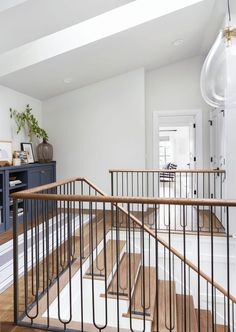 an open staircase in a home with white walls and wood floors