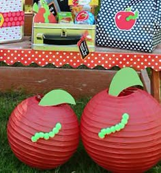 two pumpkins sitting on top of a wooden table next to bags and other items