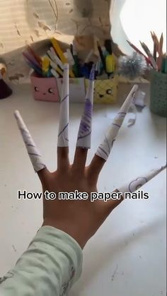 a person's hand with fake nails on it and the words how to make paper nails