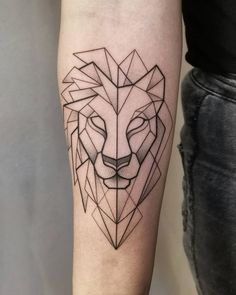 a black and white tattoo of a lion's head on the right arm, with geometric shapes