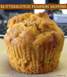 a muffin sitting on top of a table next to a computer keyboard with the title butterscotch pumpkin muffins