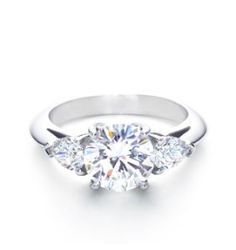 three stone diamond engagement ring in 18k white gold with diamonds on the sides and four prongs