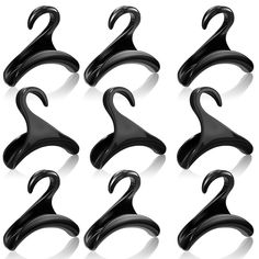 six pairs of black plastic hangers on a white background