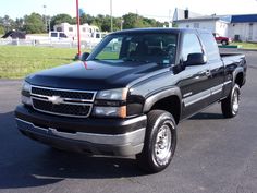 a black pickup truck parked in a parking lot