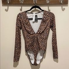 Sexy Long Sleeve Low Cut Animal Print Bodysuit. Great For A Night Out On The Town, A Halloween Costume Party Or Just For Fun. Final Sale Due To Hygiene. Please Ask Questions Before Purchasing. Item Comes From A Smoke Free Super Clean Home. *Please See All Pics And Note The Size On Item Is Large However The Store Accidentally Tagged This Item Xl. Stretch Leopard Print Bodysuit For Night Out, Flirty Fitted One-piece Bodysuit, Fitted Leopard Print Bodysuit For Party, Halloween Stretch Bodysuit For Night Out, Fitted Halloween Party Swimwear, Fitted Leopard Print Swimwear For Party, Brown Stretch Bodysuit For Night Out, Brown Long Sleeve Bodysuit For Night Out, Trendy Brown Bodysuit For Night Out