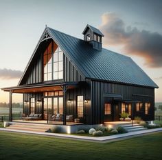 a large black house with lots of windows on the front and side of it at dusk