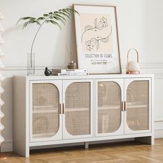 a white cabinet with wicker doors in the corner next to a plant and potted plant