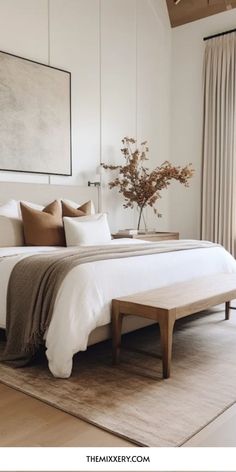 a large bed sitting in a bedroom on top of a wooden floor next to a window