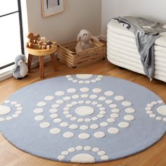 a blue and white circular rug in a child's room