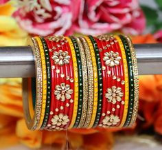 red and gold bangles with flowers in the background