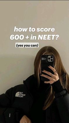 a woman taking a selfie in front of a wall with the text how to score 600 + in net? yes you can