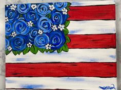 an american flag with blue flowers painted on it