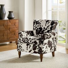 an animal print chair in front of a window