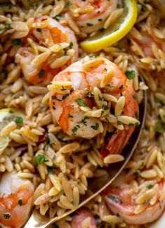 shrimp and rice with lemon wedges in a bowl