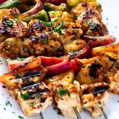 chicken and vegetable kabobs on a white plate