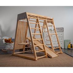 a child's wooden swing set with stairs and ladders on the floor next to a dresser