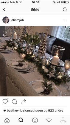 the table is set for christmas dinner with candles