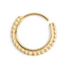 a gold colored nose ring with small beads on the outside, and an open hole in the middle