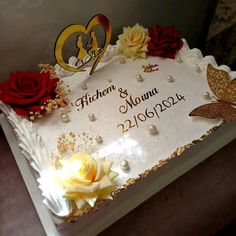 a wedding cake decorated with roses and butterflies