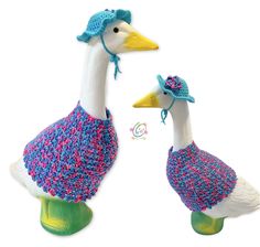 two knitted ducks wearing hats and scarves