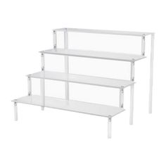 three white shelves are stacked on each other