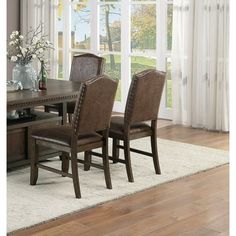 a dining room table with chairs and a rug