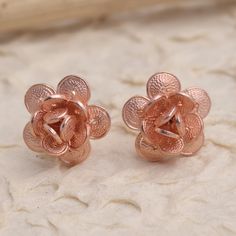 Tiny blossoms twinkle in warm rose gold in these hand crafted button earrings from Bali's Yuniati. Designed from 18k rose gold plated sterling silver filigree these enticing earrings are hand crafted with coin-shaped petals and completed with a combination finish. Rose Gold Flower Charm Earrings, Rose Gold Round Flower Charm Earrings, Round Rose Gold Flower Charm Earrings, Formal Rose Gold Flower Earrings, Rose Gold Earrings With Rose Flower Design, Rose Gold Flower-shaped Earrings For Anniversary, Rose Gold Round Flower Earrings For Anniversary, Elegant Rose Gold Flower Earrings For Gift, Rose Gold Flower-shaped Jewelry With Matching Earrings