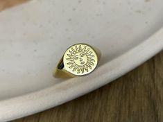 gold sun signet ring ♡ this beautifully engraved signet ring is a delicate piece of jewelry  to wear with any combination. the ring has solid back the face of the ring is 11 mm round materials: 10k gold 14k gold 14k rose gold 14k white gold 925 sterling silver 14k gold plated over silver 14k rose gold plated over silver gold/rose gold plated is genuine 925 sterling silver that has been expertly plated with a thick layer of 14k gold/rose gold size: we offer sizes from 3 to 13 1/2 for bigger size requests, please send a message ♡ important note about the ring size: ♡ to be able to make a ring which fits perfectly we kindly ask you to double check your finger size as shown in the picture in our gallery before placing your order shipping: ♡ all our listings include free expedited shipping deli Symbolic Gold Rings With Sun And Moon Design, Gold Celestial Engraved Ring As Gift, Celestial Yellow Gold Signet Ring Gift, Celestial Style Yellow Gold Signet Ring Gift, Celestial Style Gold Signet Ring As Gift, Gold Rings With Sun Design As Gift, Gold Rings With Sun Design For Gift, Engraved Signet Ring, Pinky Signet Ring