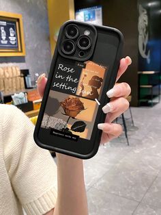 a woman holding up her cell phone case with an image of a rose on it