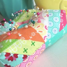 a close up of a pin cushion on a table