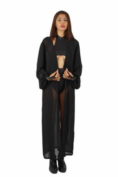 Effortlessly stylish and super versatile, our sheer black robe goes with everything in your closet. Layer it over bodysuits to keep the sun off your skin and layer it under accessories like a harness or shoulder holster bags for a unique look. FEATURES: Maxi length Made with medium weight deadstock sheer black chiffon Translucent, not completely transparent Long princess sleeves with button cuffs Removable belt Ethically handmade and 100% carbon neutral FIT NOTES:This sheer black robe is designe