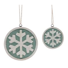 two snowflake ornaments are hanging from twine strings on a white background, one is green and the other is white