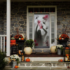 the front porch decorated for halloween with fake hands and pumpkins on display in pots