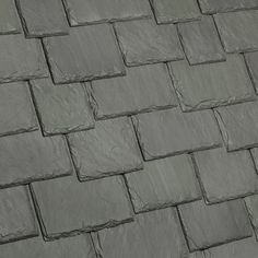 a close up view of a tile roof with gray tiles on the top and bottom