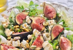 a salad with figs, feta cheese and walnuts on it is served in a bowl