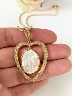 Virgen de Guadalupe Necklace MATERIAL AND SIZE Mother of pearl connector Cubic zirconia 18k gold plated Pendant size: 3.5cmx3cm If you have questions about the product, feel free to reach me out. Don't forget to check out my other items in the store: Https://www.etsy.com/shop/nyahwithlove Miraculous Medal Necklace For Mother's Day Gift, Miraculous Medal Jewelry Gift For Mother's Day, Mother's Day Gift Jewelry With Miraculous Medal, Spiritual Miraculous Medal Necklaces For Anniversary, Miraculous Medal Pendant Jewelry For Wedding, Spiritual Pendant Jewelry For First Communion, Miraculous Medal Wedding Pendant Jewelry, Wedding Miraculous Medal Pendant Jewelry, Virgin Mary Pendant Jewelry As A Gift