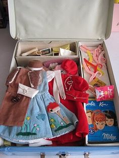 an open suitcase filled with clothes and toys