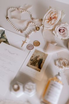 the wedding stationery is laid out on top of the table