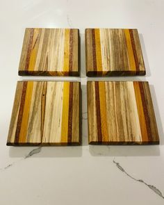 three wooden coasters sitting on top of a white counter