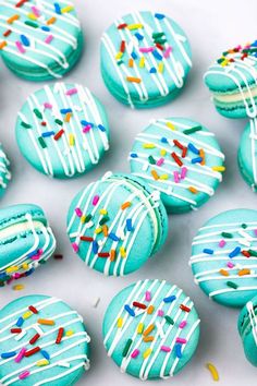 blue decorated cookies with white frosting and sprinkles on them, text reads how to make macarons with cream cheese filling