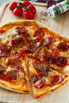 a pepperoni pizza cut into slices on a cutting board