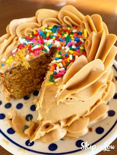 a piece of cake with frosting and sprinkles on a polka dot plate