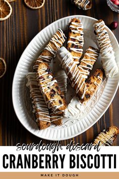 cranberry biscotti on a white plate with oranges