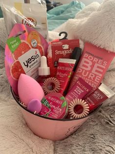 a pink bowl filled with lots of different items on top of a white furnish