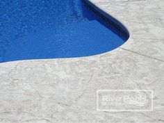 an empty swimming pool with blue water