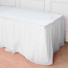 a white table cloth on top of a wooden floor