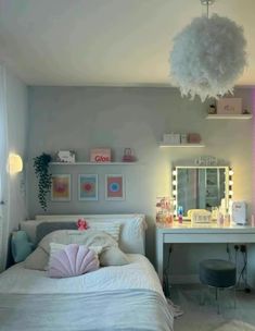 a bedroom with a bed, desk and mirror in it's corner is lit up by pink lights